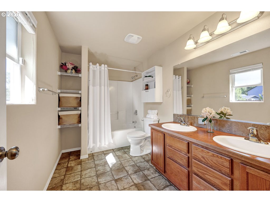 87836 8th Street Veneta, OR 97487 - Photo 9 of 25 a bathroom with a sink a toilet and shower