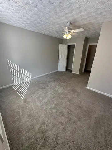 a view of a livingroom with a chandelier fan