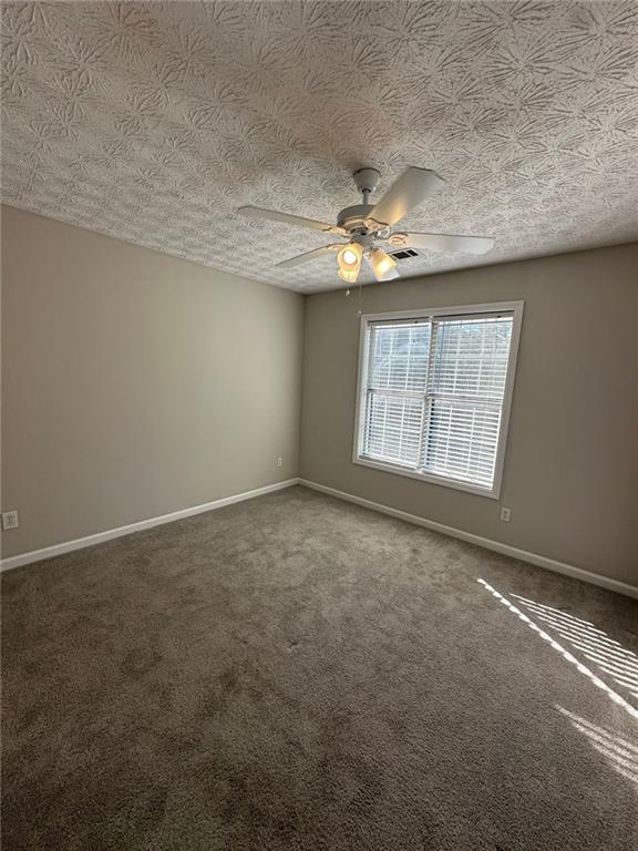 3993 Paloverde Drive Kennesaw, GA 30144 - Photo 19 of 25 an empty room with windows and ceiling fan