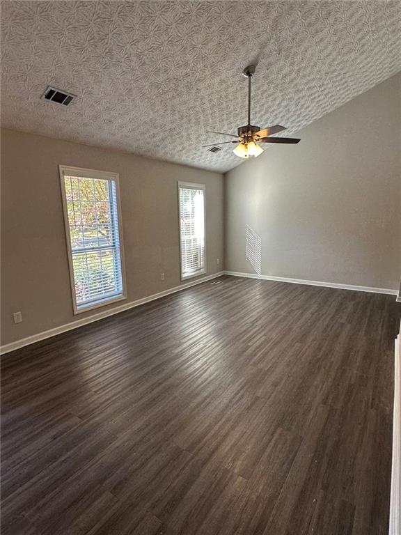 3993 Paloverde Drive Kennesaw, GA 30144 - Photo 3 of 25 an empty room with wooden floor chandelier and windows