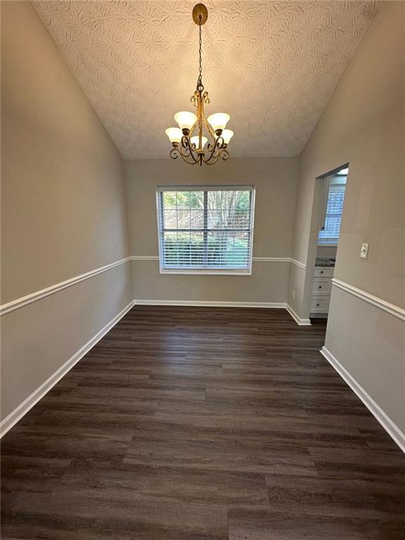 3993 Paloverde Drive Kennesaw, GA 30144 - Photo 4 of 25 wooden floor in an empty room with a window