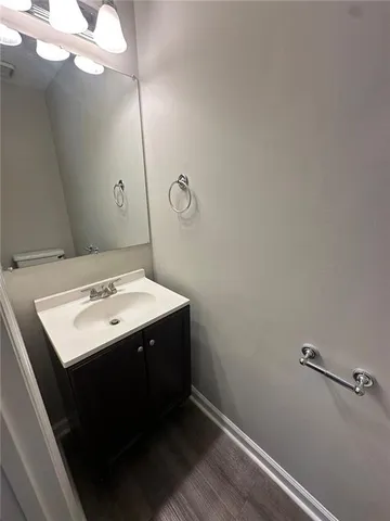 a bathroom with a sink a mirror and vanity