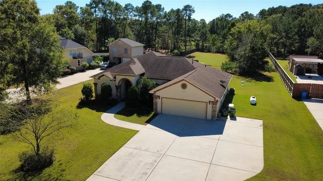 a aerial view of a house with swimming pool and yard