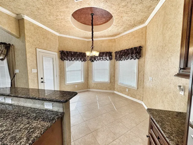 a view of a living room and kitchen with stainless steel appliances