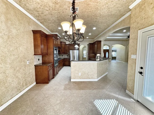 a kitchen with stainless steel appliances granite countertop a sink refrigerator and cabinets