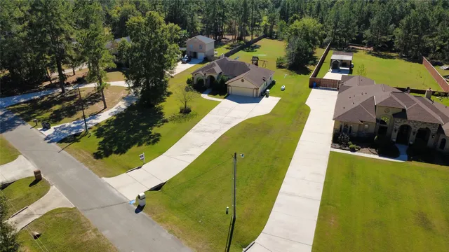 an aerial view of house with a yard