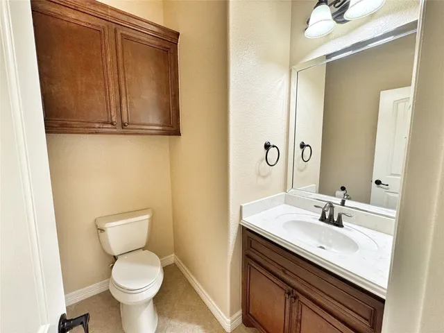a view of an empty room with a fireplace and a chandelier