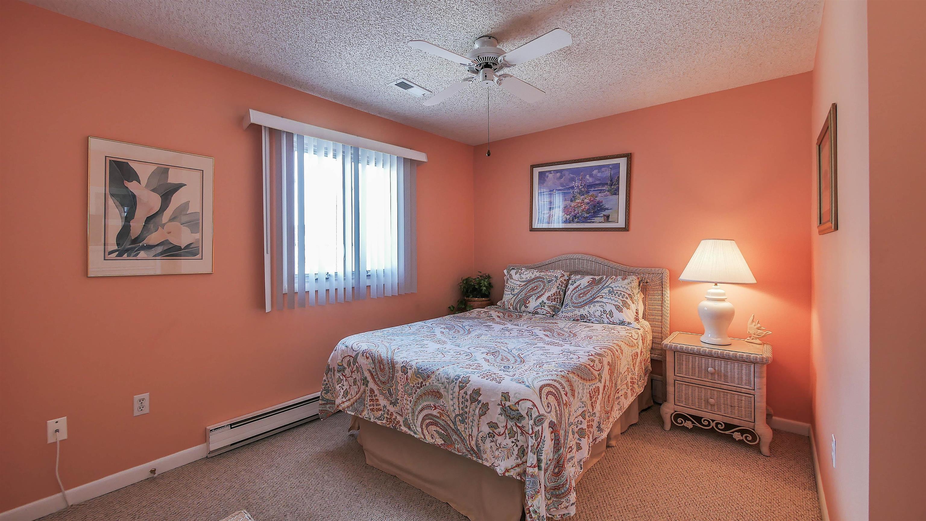 4025 4th, Unit TOP Avalon, NJ 08202 - Photo 14 of 32 a bedroom with a bed and a window