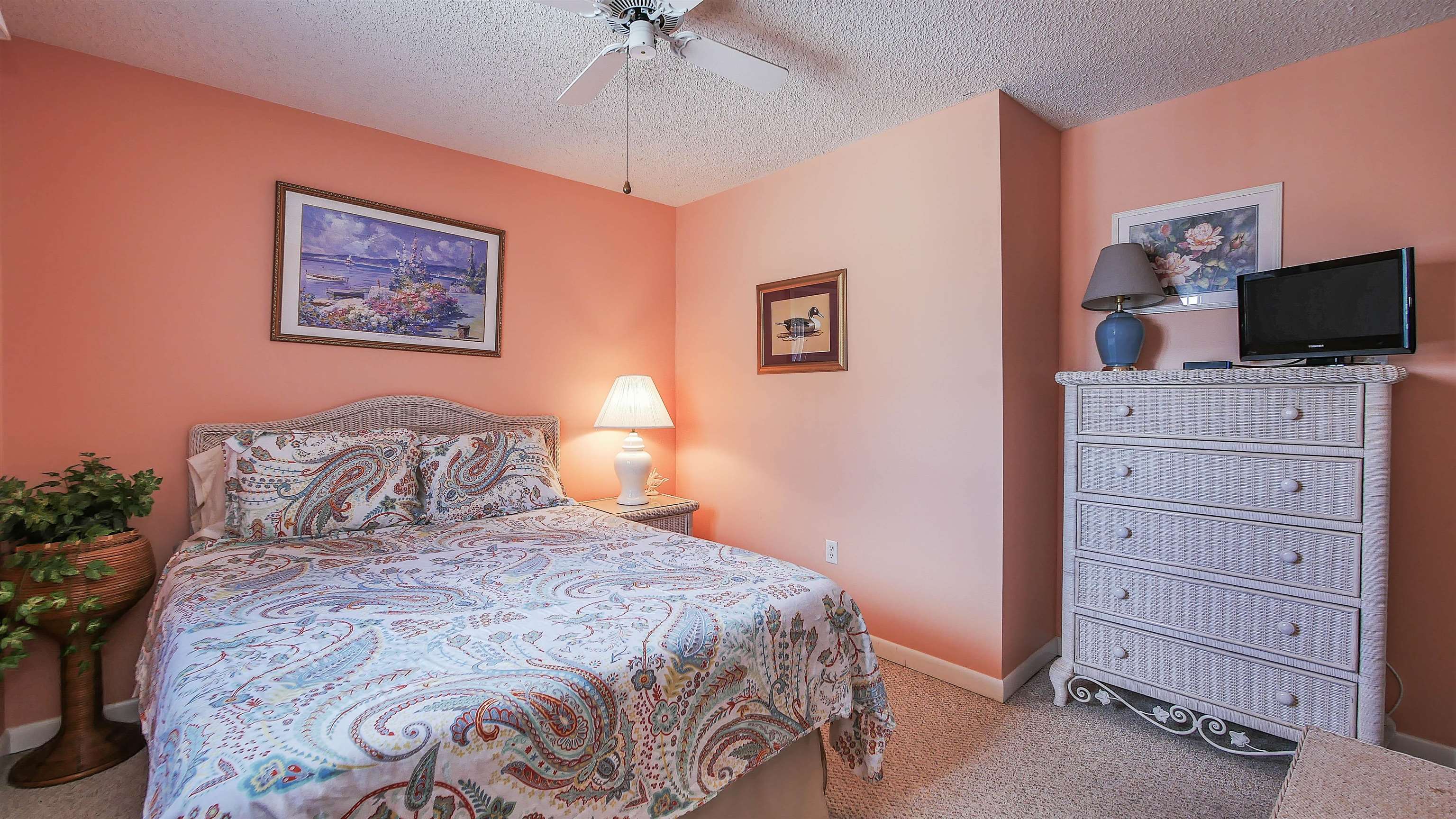 4025 4th, Unit TOP Avalon, NJ 08202 - Photo 15 of 32 a bedroom with a large bed and a flat screen tv