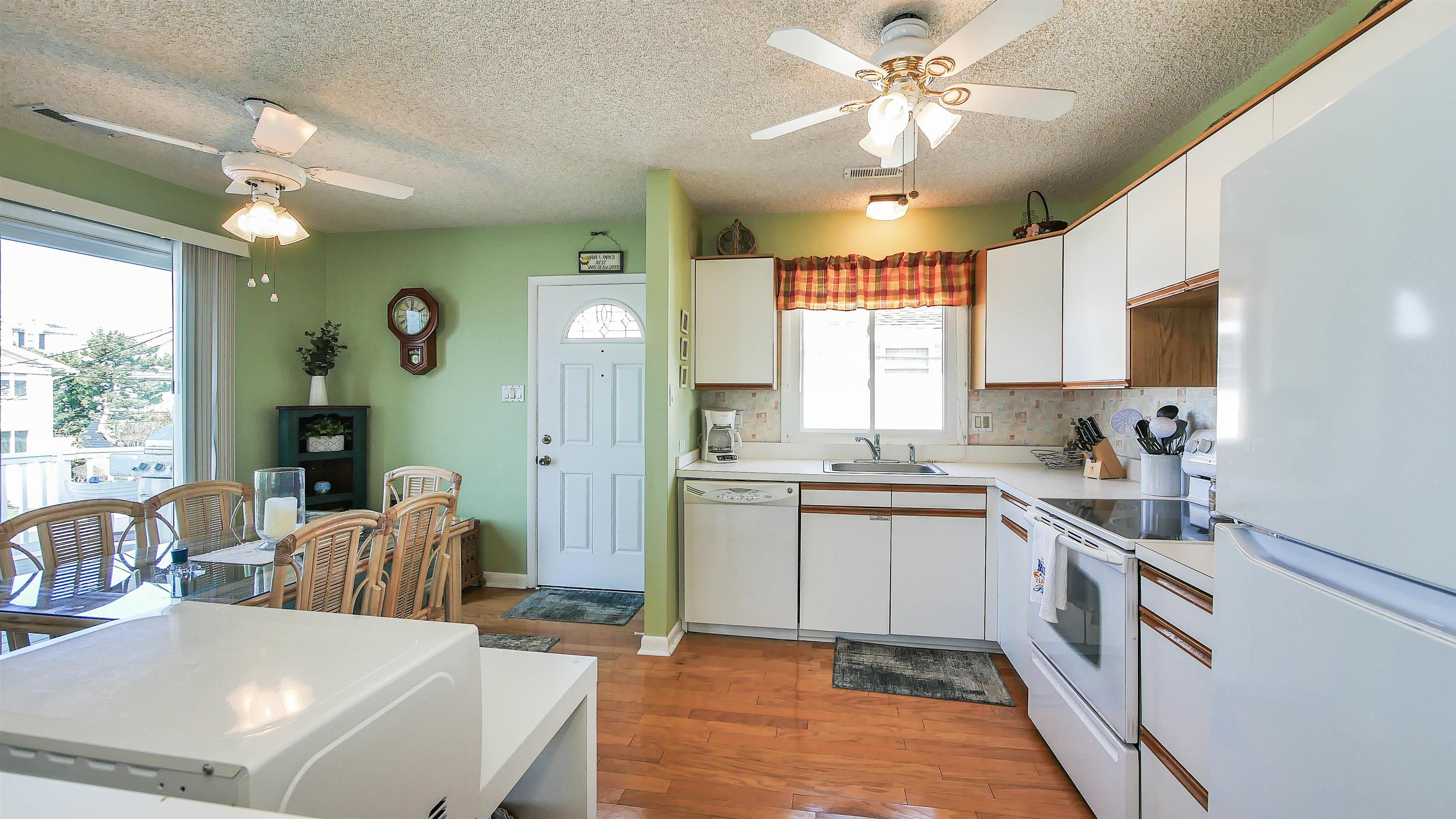 4025 4th, Unit TOP Avalon, NJ 08202 - Photo 20 of 32 a kitchen with a sink stove and cabinets