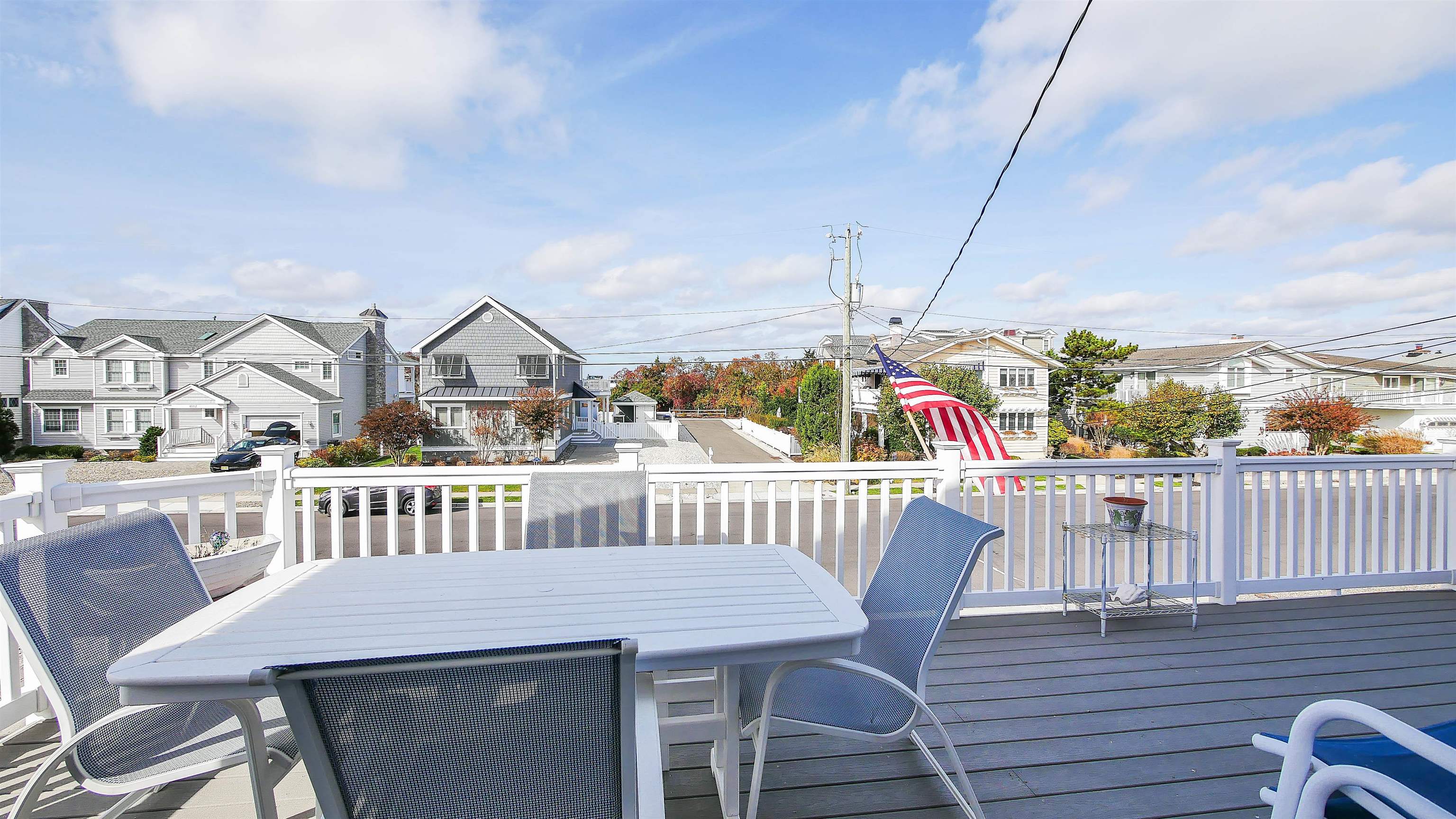 4025 4th, Unit TOP Avalon, NJ 08202 - Photo 23 of 32 a view of a deck with two chair and table