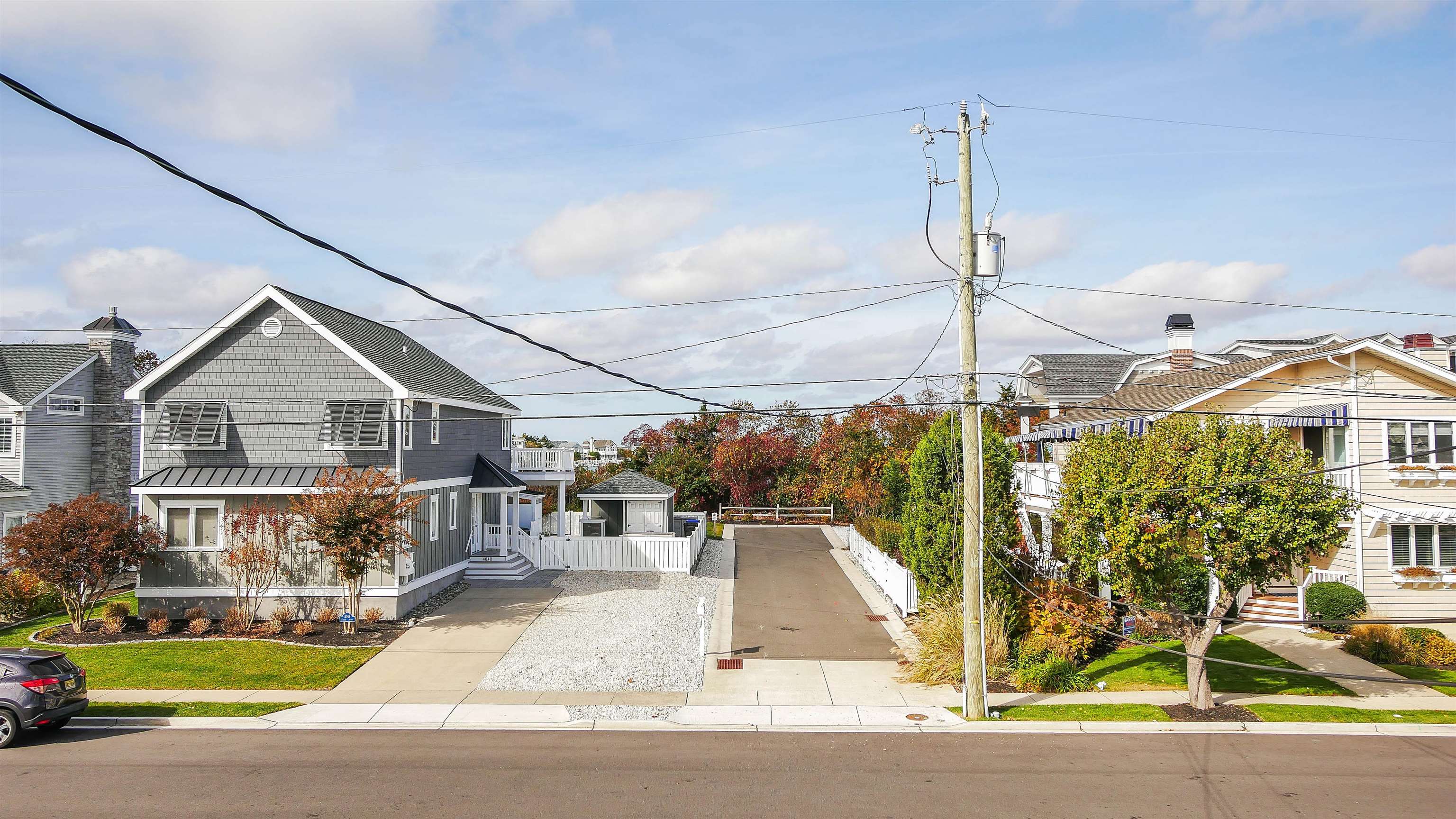 4025 4th, Unit TOP Avalon, NJ 08202 - Photo 25 of 32 a view of a white house in front of a yard