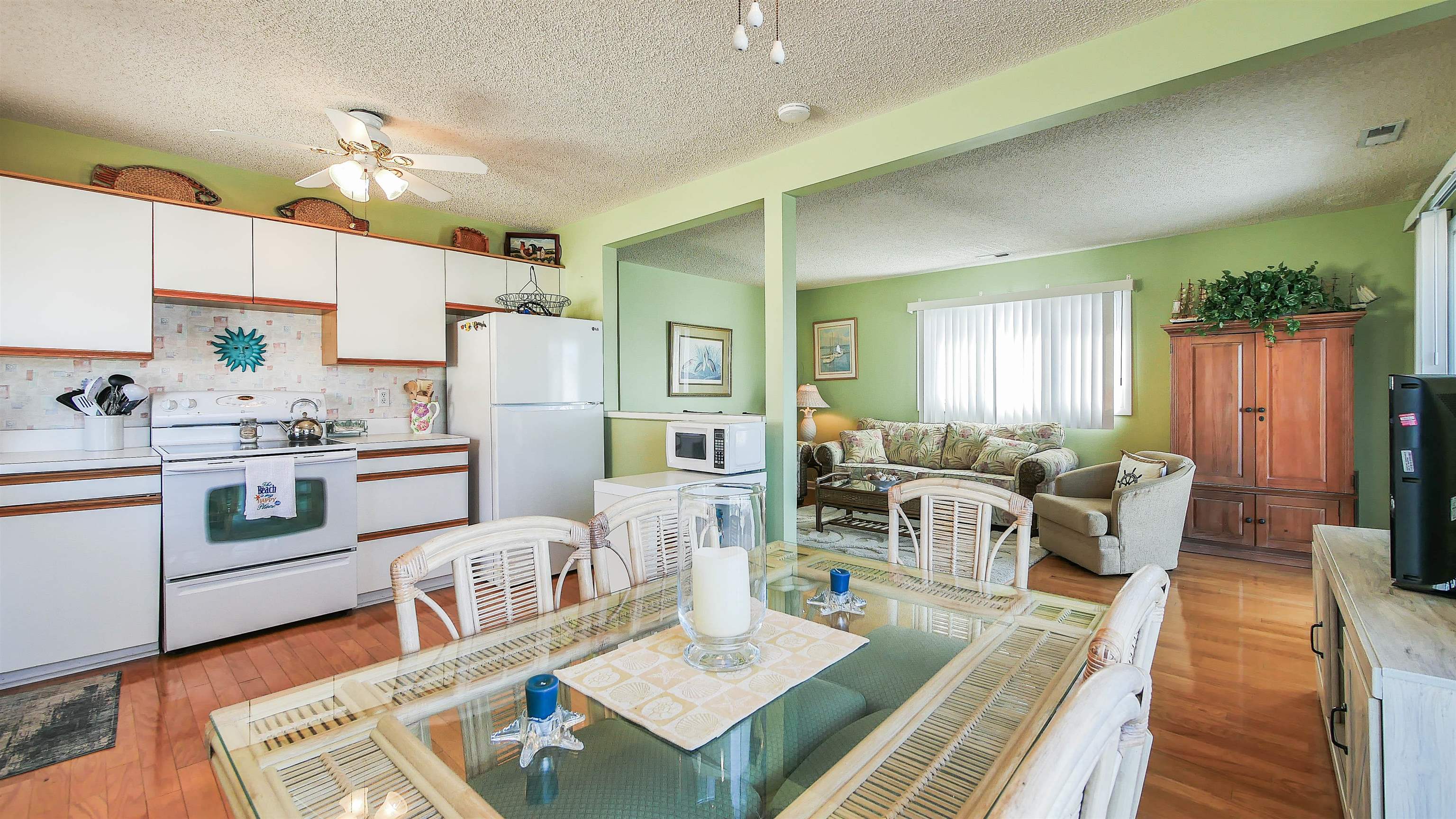 4025 4th, Unit TOP Avalon, NJ 08202 - Photo 32 of 32 a living room with kitchen island furniture and a kitchen view