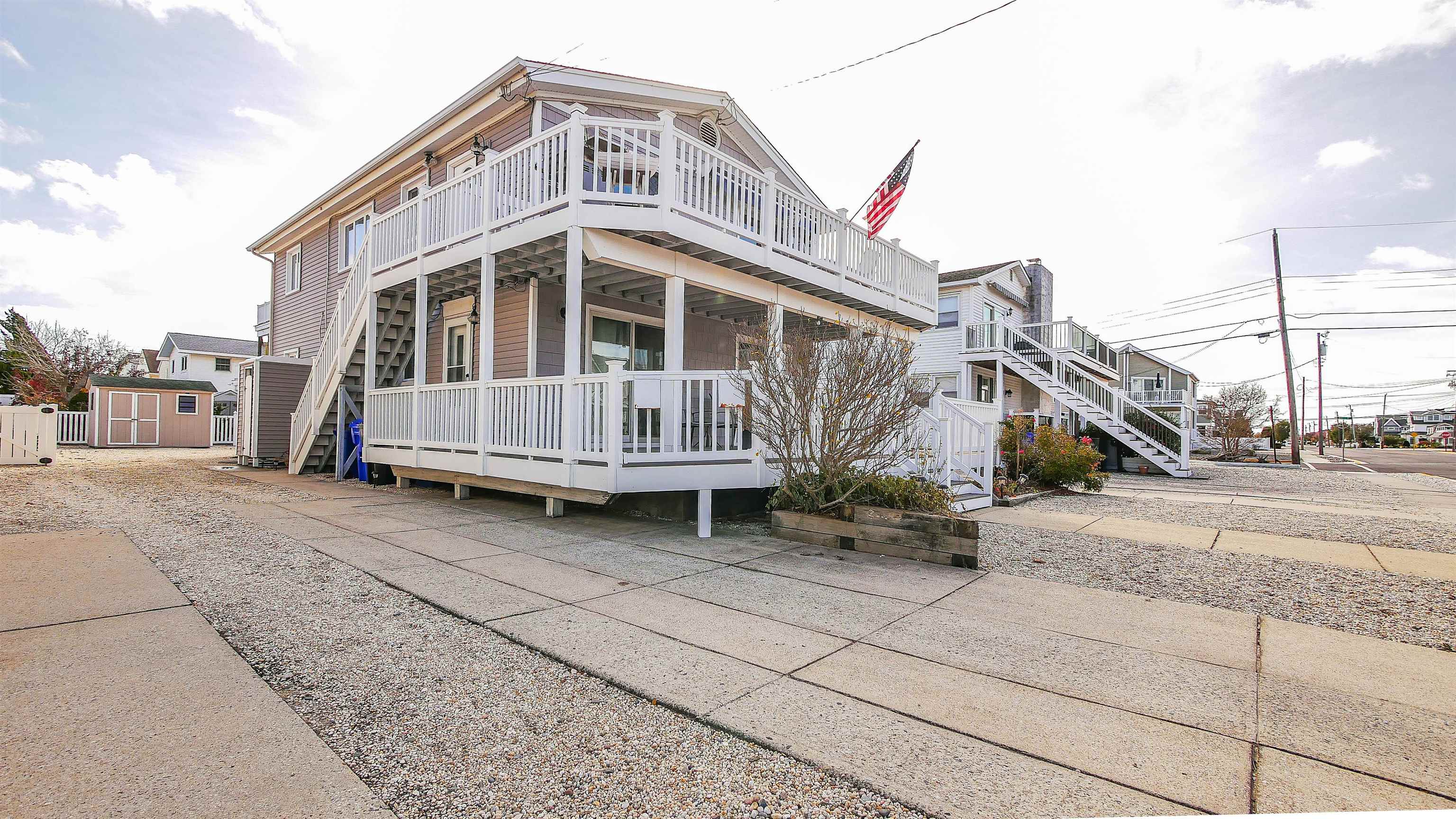 4025 4th, Unit TOP Avalon, NJ 08202 - Photo 4 of 32 a view of a house with a wooden deck