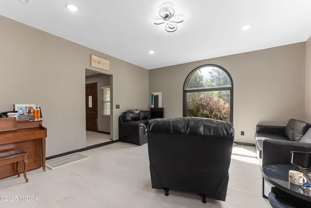 a living room with furniture and a large window