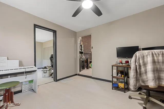 a view of a workspace with furniture and a bedroom