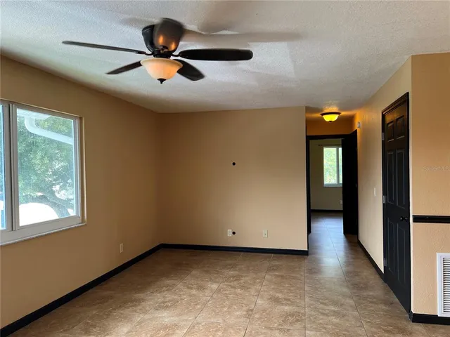 a view of a livingroom with a ceiling fan and window
