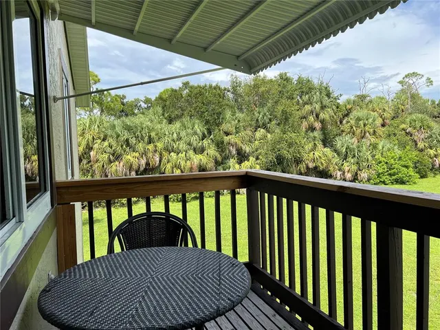 a view of a balcony with furniture