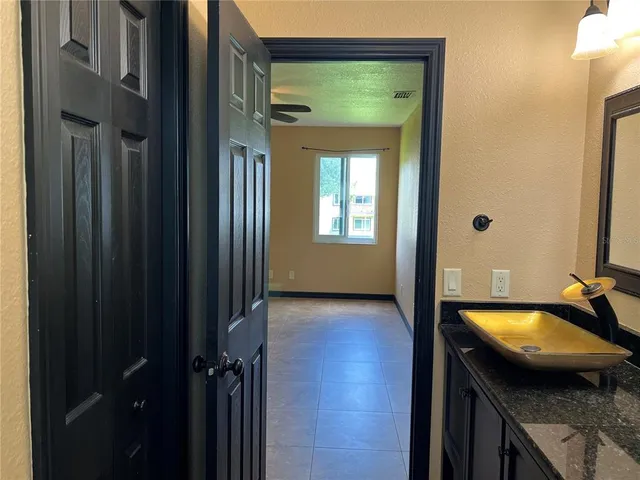 a bathroom with a sink mirror and toilet