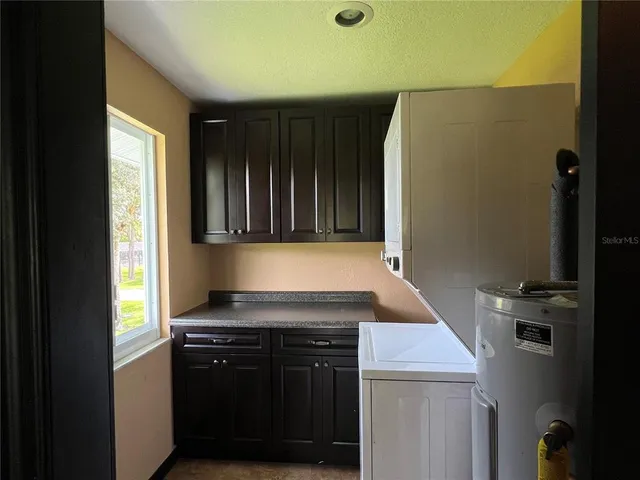 a kitchen with a refrigerator and a stove top oven