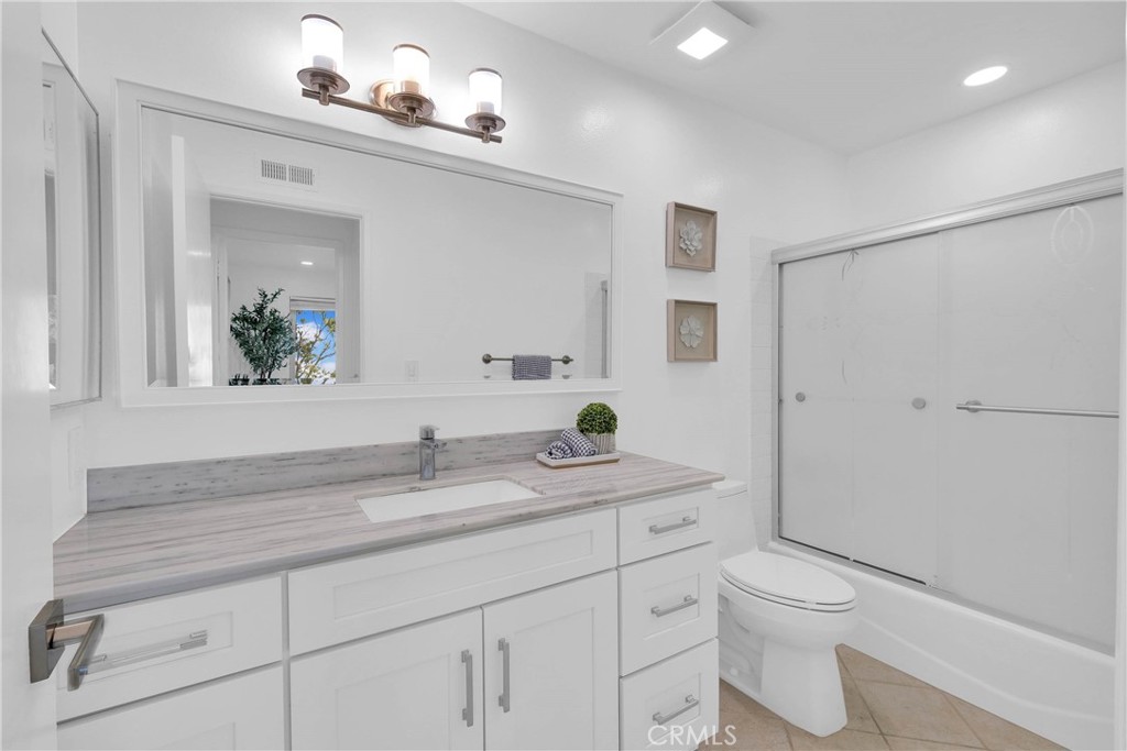 28127 Ridgethorne Court Rancho Palos Verdes, CA 90275 - Photo 25 of 36 a bathroom with a granite countertop sink a toilet and a mirror