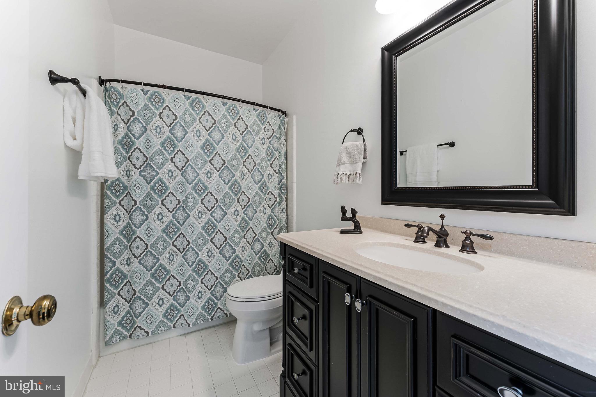 1210 Windrock Drive McLean, VA 22102 - Photo 21 of 84 a bathroom with a sink and a mirror