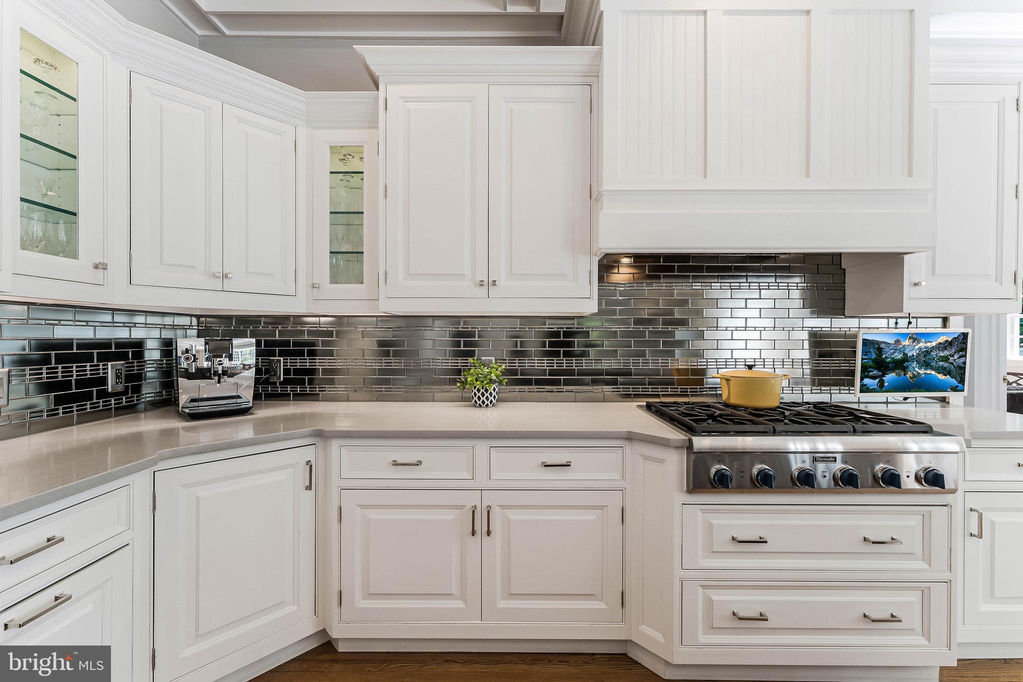1210 Windrock Drive McLean, VA 22102 - Photo 10 of 84 a kitchen with white cabinets and appliances
