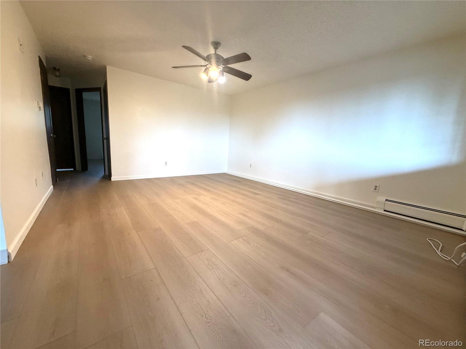 6155 Simms Street, Unit 2 Arvada, CO 80004 - Photo 6 of 7 an empty room with fan