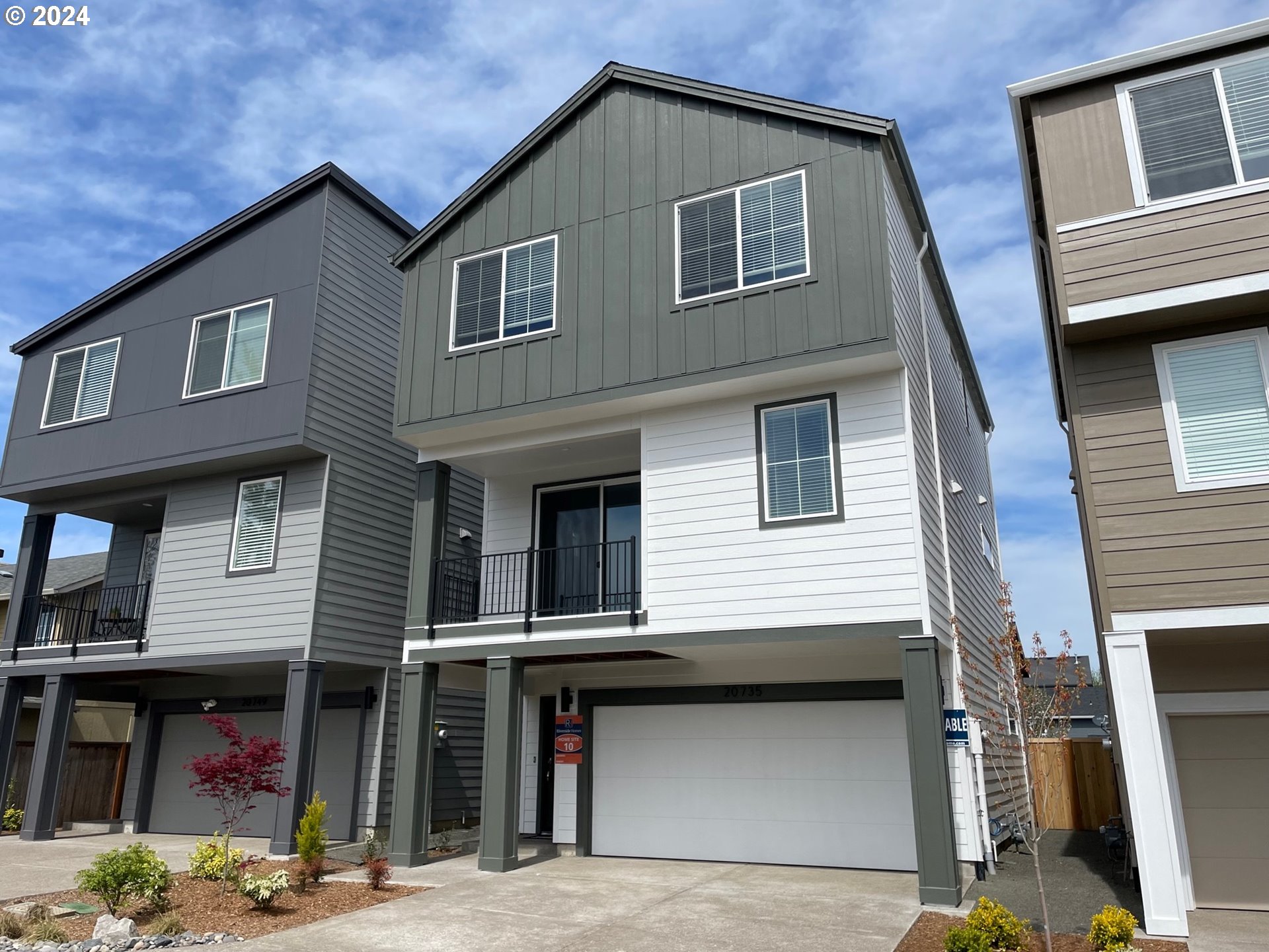 20735 Southwest Boyd Court, Unit 10 Beaverton, OR 97003 - Photo 1 of 47 a front view of a house with a garage