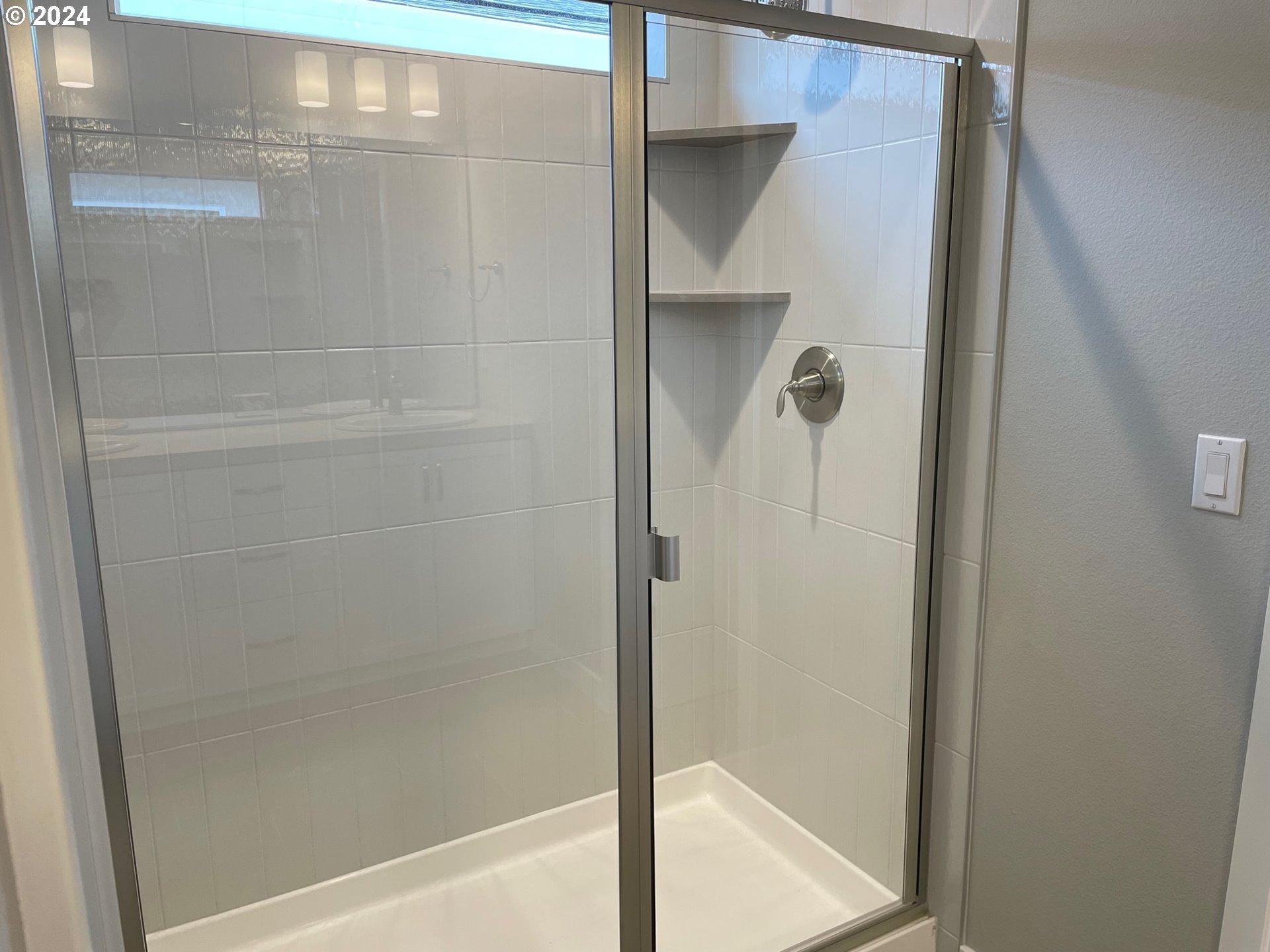 20735 Southwest Boyd Court, Unit 10 Beaverton, OR 97003 - Photo 11 of 47 a bathroom with a glass shower door