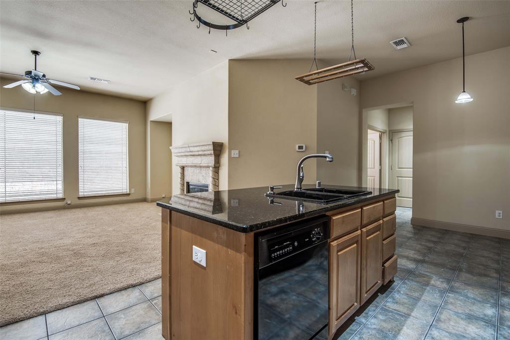 6781 Camino Rio Irving, TX 75039 - Photo 14 of 25 a kitchen with granite countertop a sink and a stove