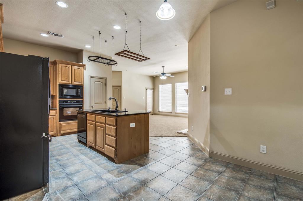 6781 Camino Rio Irving, TX 75039 - Photo 16 of 25 a kitchen with stainless steel appliances granite countertop a refrigerator and a sink
