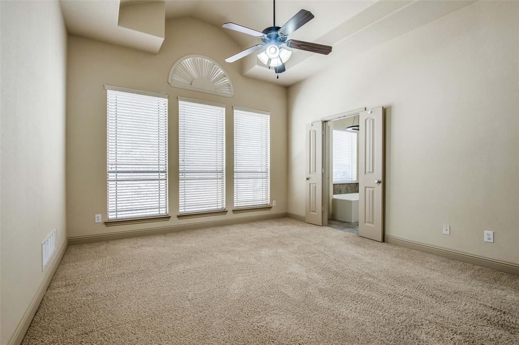 6781 Camino Rio Irving, TX 75039 - Photo 18 of 25 an empty room with chandelier fan and windows