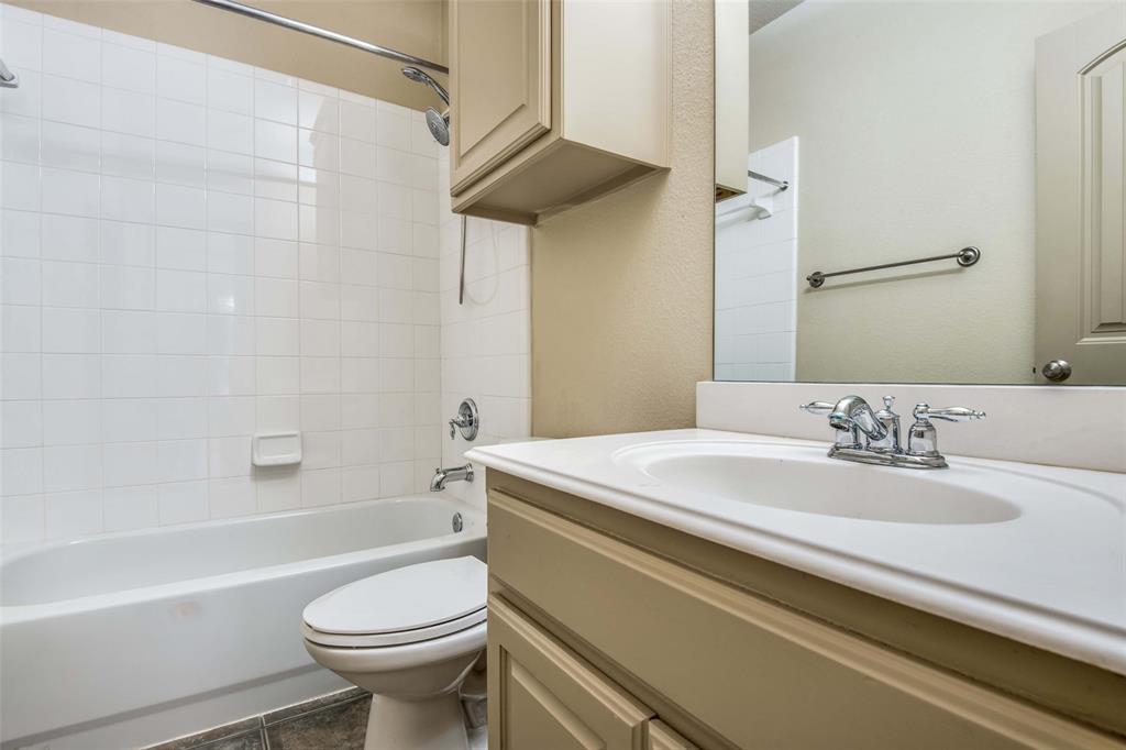 6781 Camino Rio Irving, TX 75039 - Photo 22 of 25 a bathroom with a sink a toilet and a bathtub