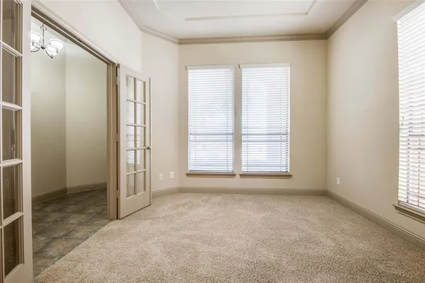 an empty room with fireplace and windows