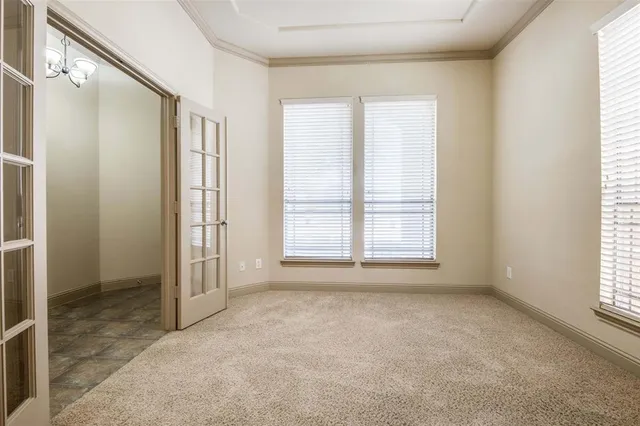 an empty room with fireplace and windows