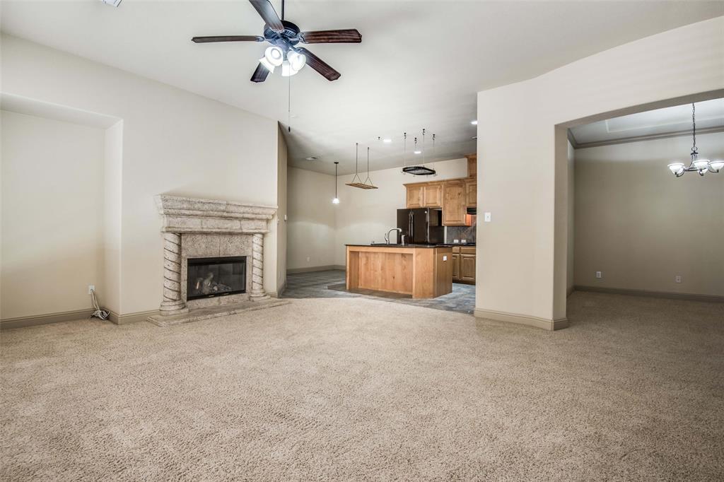 6781 Camino Rio Irving, TX 75039 - Photo 8 of 25 an empty room with fireplace and windows