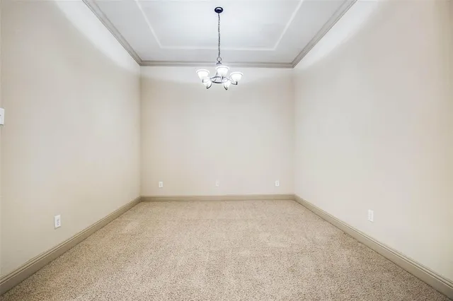 an empty room with windows and ceiling fan