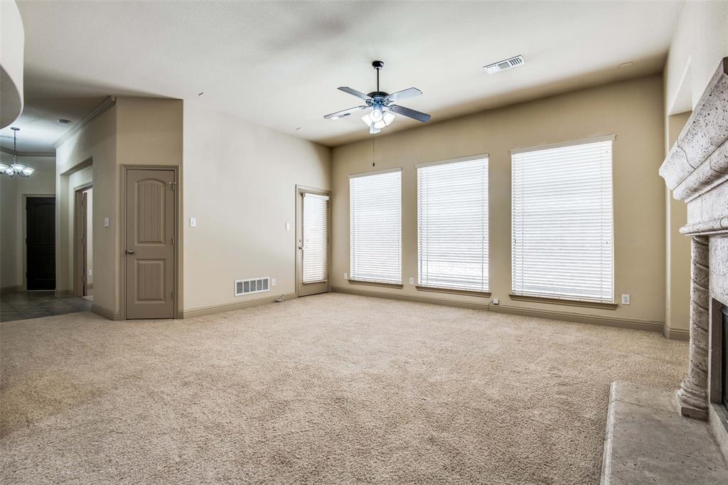 6781 Camino Rio Irving, TX 75039 - Photo 10 of 25 an empty room with windows and ceiling fan