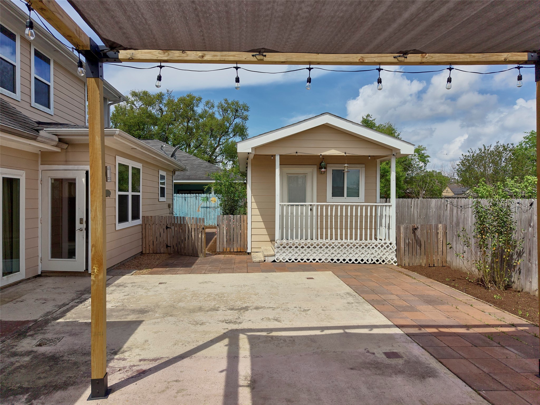 4219 Redbud Street Houston, TX 77051 - Photo 3 of 25 This inviting backyard features a separate, cooled office space perfect for remote work or creative projects, nestled amidst a charming outdoor setting.