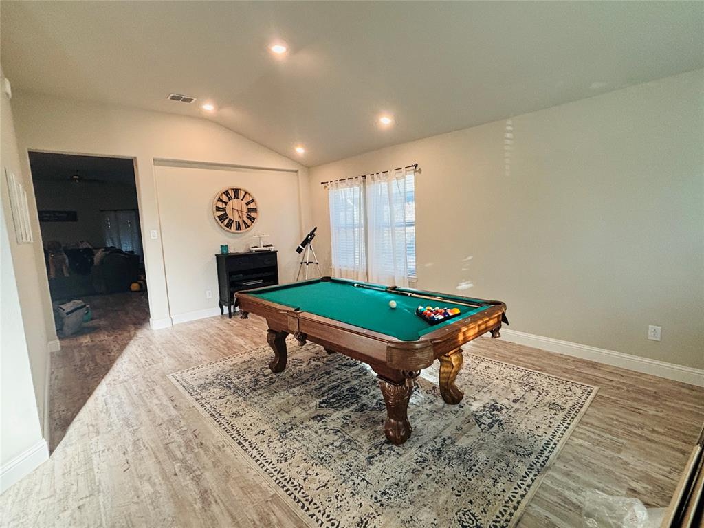 6820 Elm Street Rowlett, TX 75089 - Photo 2 of 12 a living room with a table and a rug