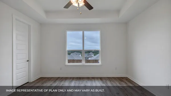 a view of kitchen with stainless steel appliances refrigerator oven stove and white cabinets with wooden floor