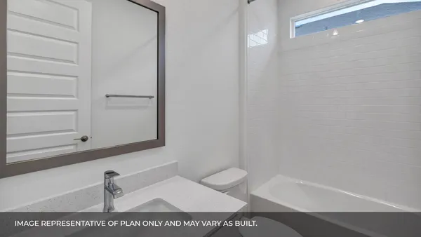 a kitchen with stainless steel appliances granite countertop a refrigerator a stove and white cabinets with wooden floor