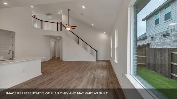 a kitchen with stainless steel appliances granite countertop a refrigerator a sink dishwasher a stove and white countertops with wooden floor