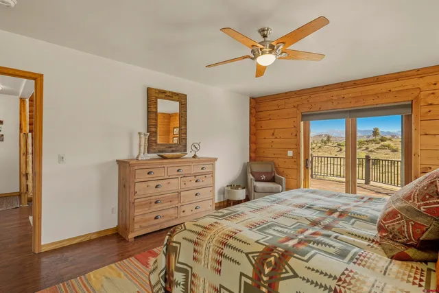 a bedroom with a bed and a ceiling fan