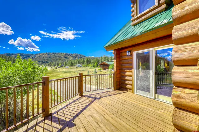 a view of a balcony with wooden floor