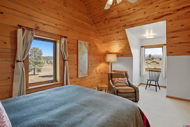a bedroom with furniture and a window