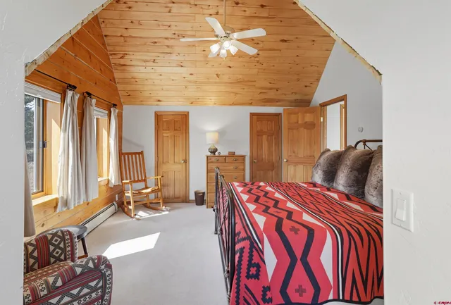 a bedroom with furniture and a large window