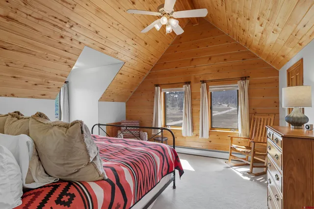 a bedroom with double bed and a window