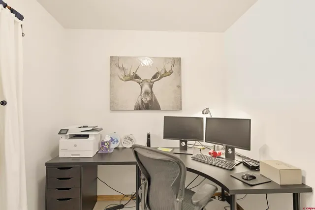 a view of a workspace with furniture